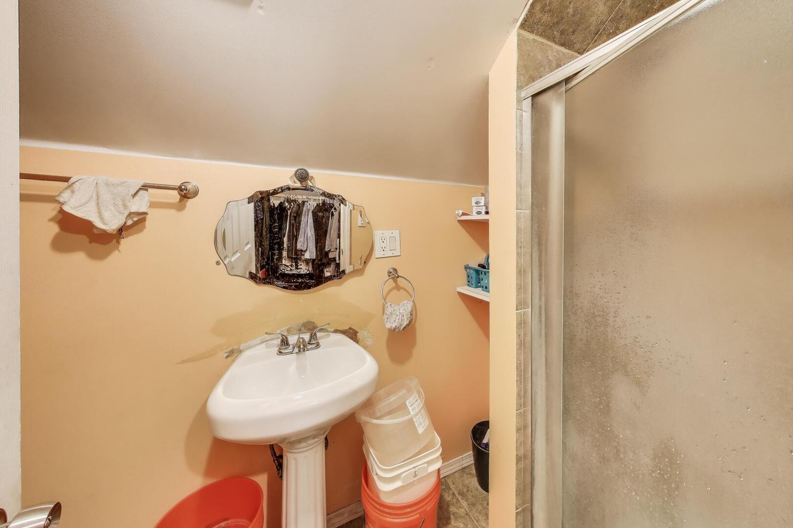 8822 South Ada Street Chicago, IL 60620 - Photo 17 of 25 a bathroom with a sink and a mirror