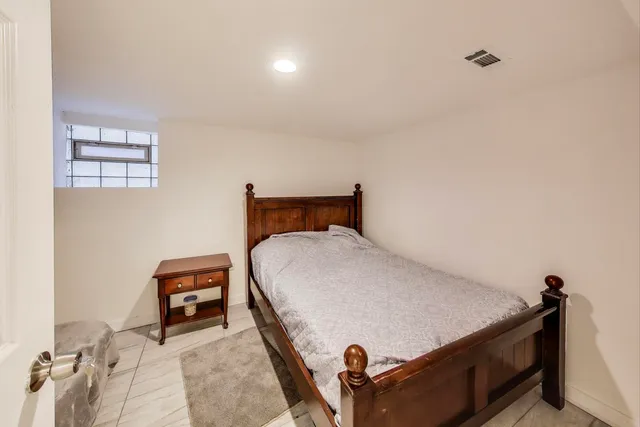 a bedroom with a bed and a dresser