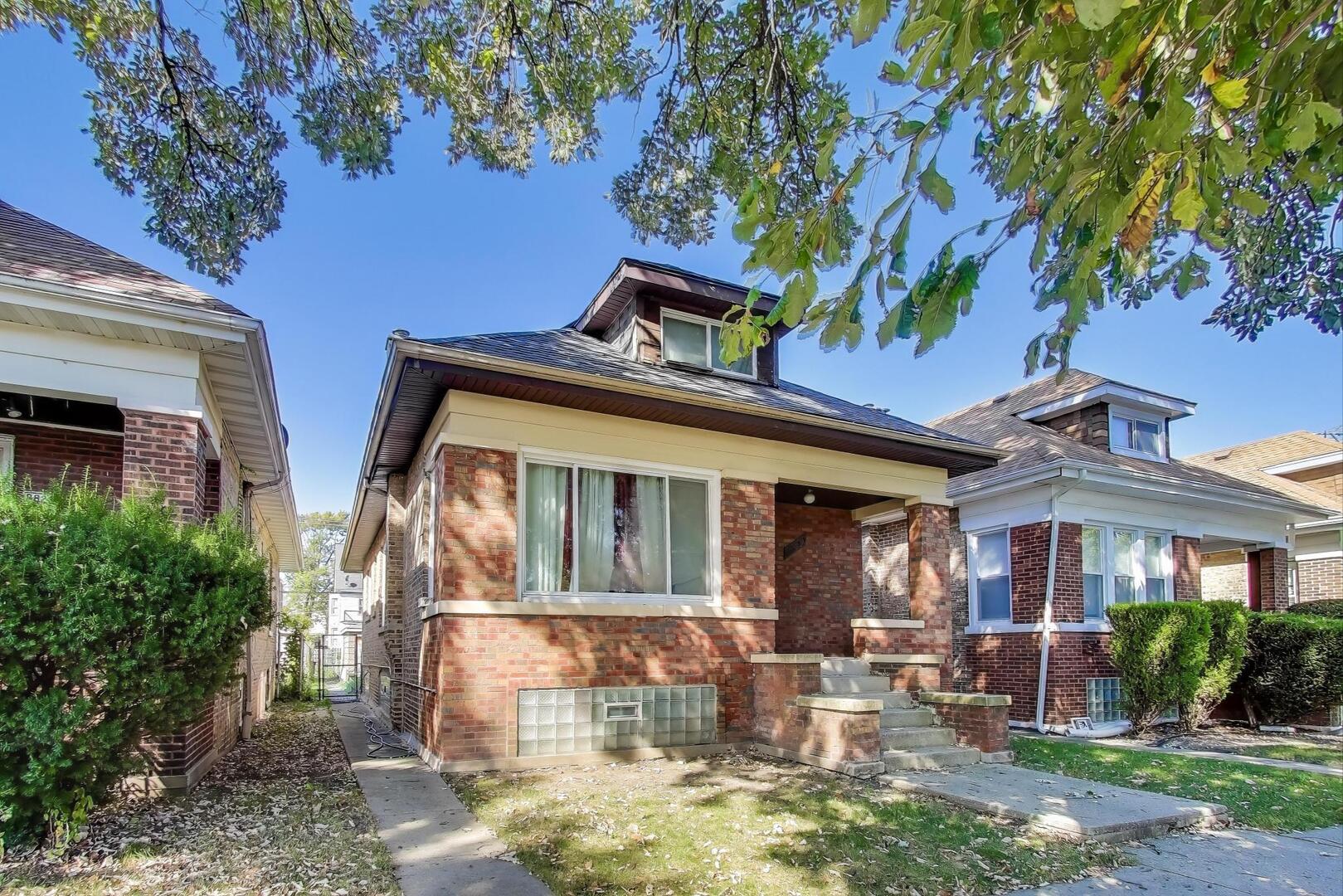 8822 South Ada Street Chicago, IL 60620 - Photo 3 of 25 a front view of house with a yard
