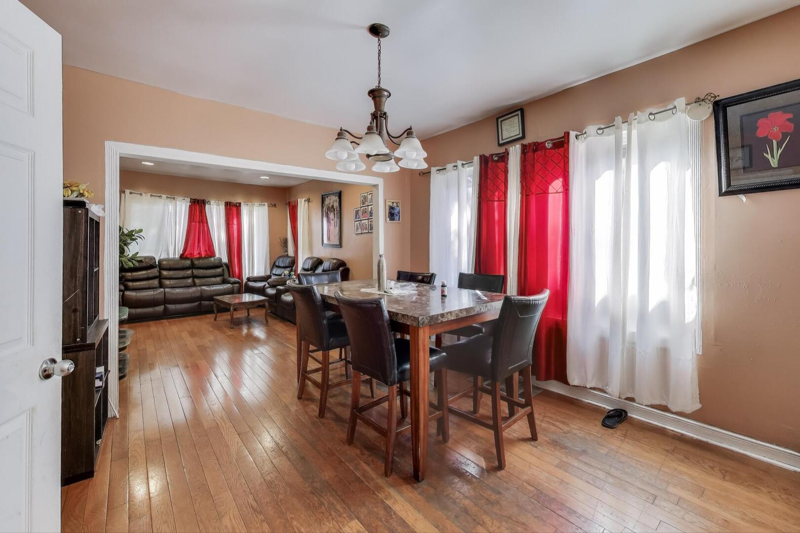 8822 South Ada Street Chicago, IL 60620 - Photo 4 of 25 a view of a dining room with furniture window and wooden floor