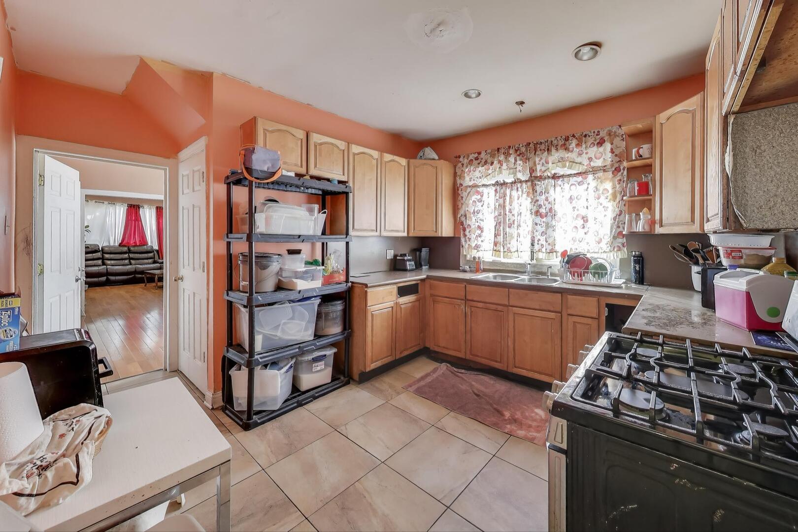 8822 South Ada Street Chicago, IL 60620 - Photo 5 of 25 a kitchen with stainless steel appliances a stove a sink and a refrigerator