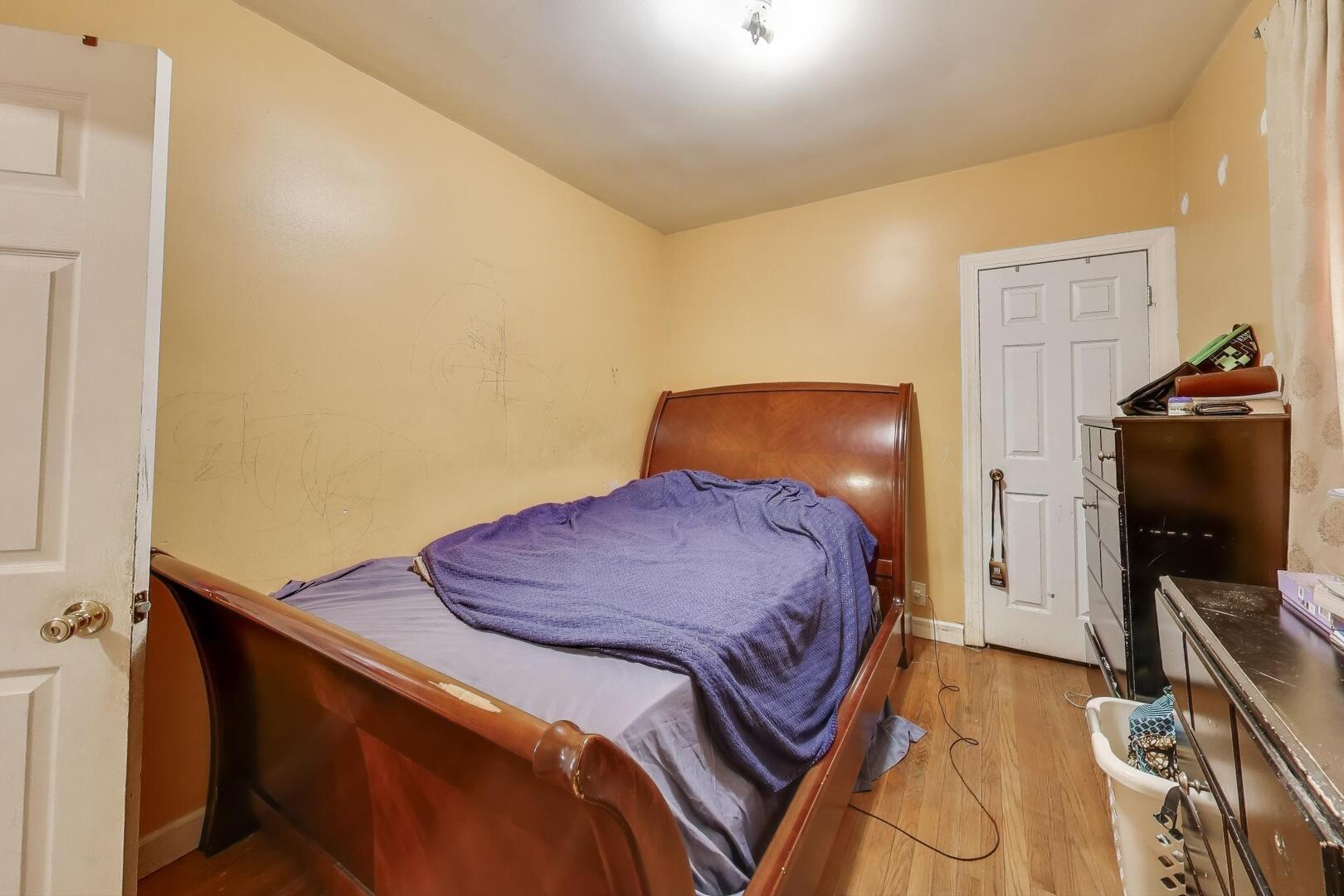 8822 South Ada Street Chicago, IL 60620 - Photo 7 of 25 a bedroom with a bed and a flat screen tv