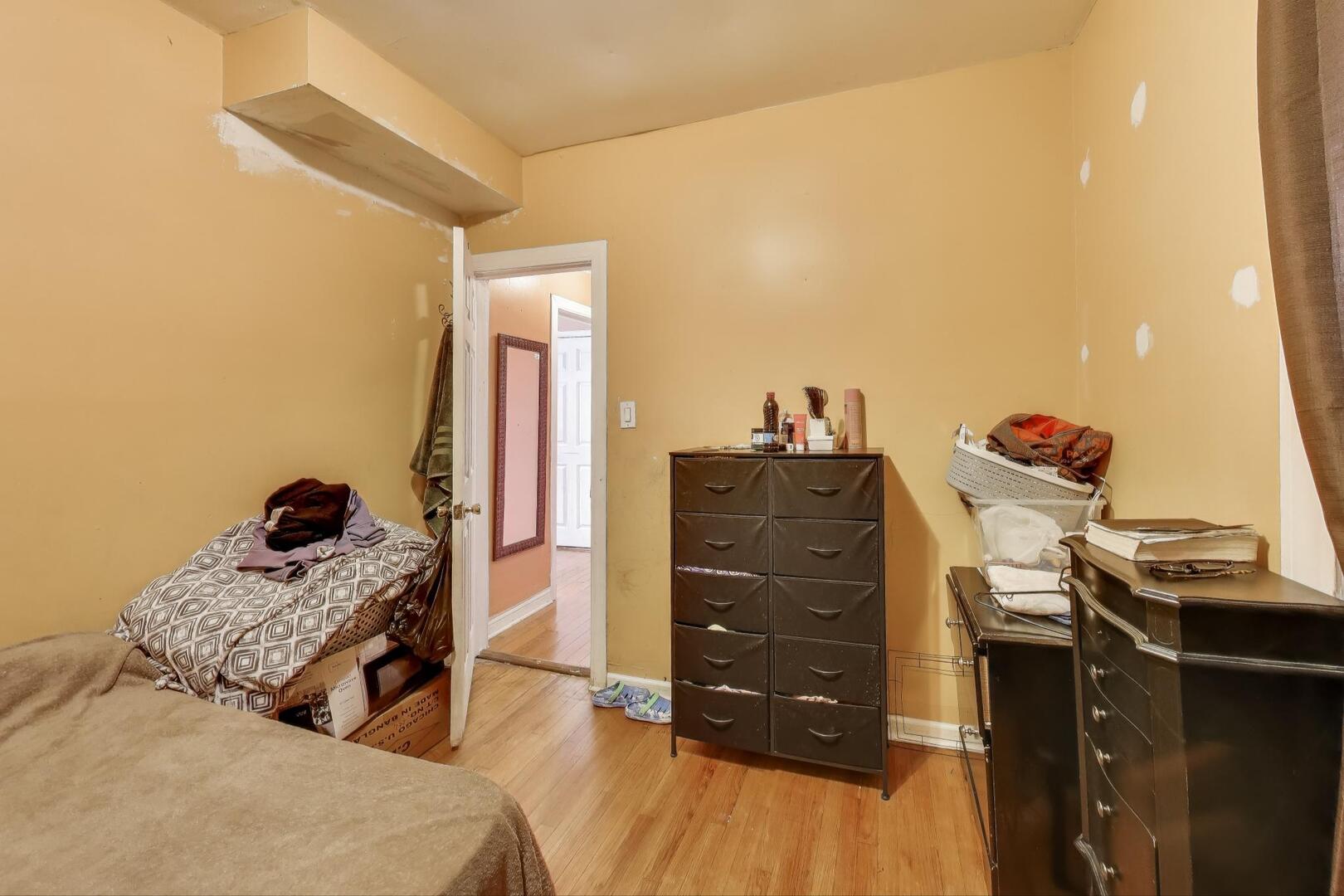 8822 South Ada Street Chicago, IL 60620 - Photo 10 of 25 a bedroom with a bed and a dresser