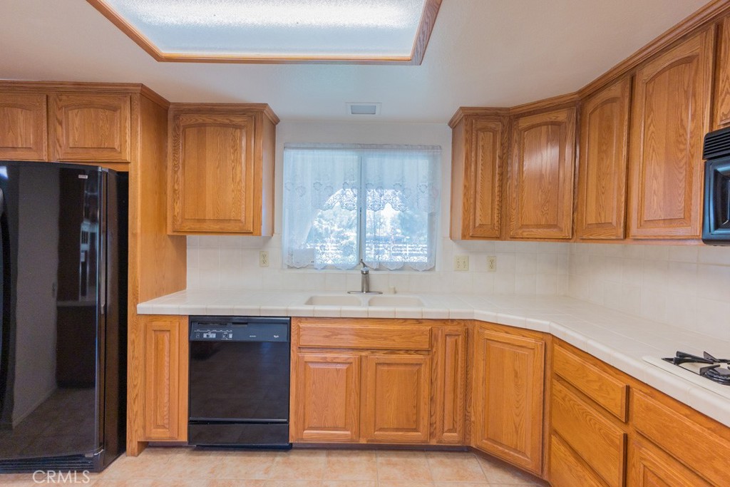4628 West Ave K8 Quartz Hill, CA 93536 - Photo 12 of 57 a kitchen with stainless steel appliances granite countertop a refrigerator and a sink