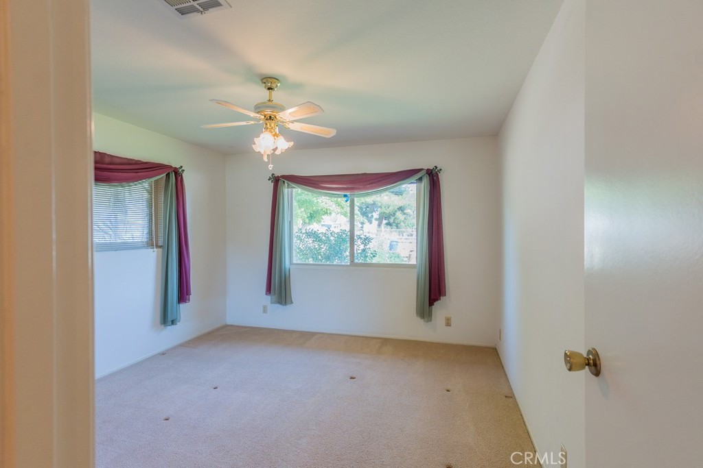 4628 West Ave K8 Quartz Hill, CA 93536 - Photo 19 of 57 a view of a room with a ceiling fan and a window