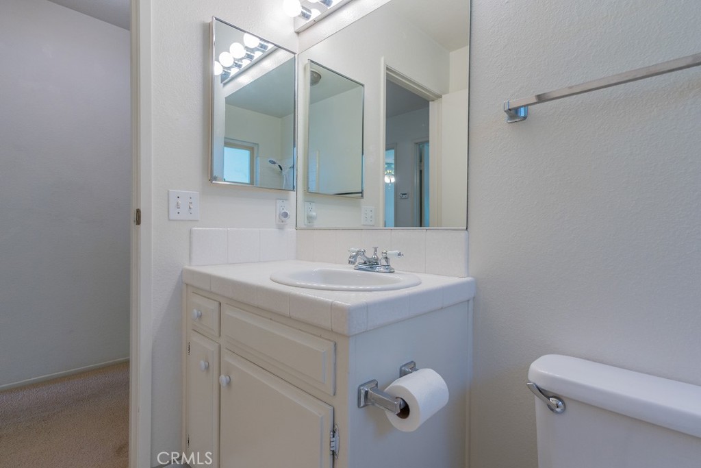 4628 West Ave K8 Quartz Hill, CA 93536 - Photo 23 of 57 a bathroom with a sink a toilet and a mirror
