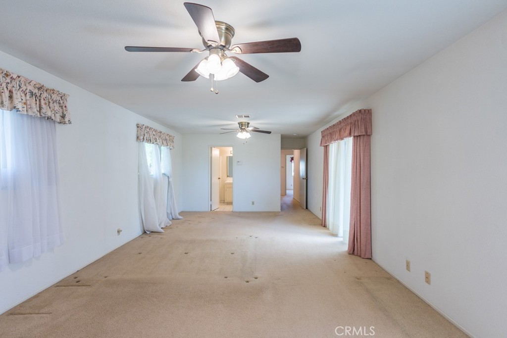 4628 West Ave K8 Quartz Hill, CA 93536 - Photo 24 of 57 an empty room with windows and fan