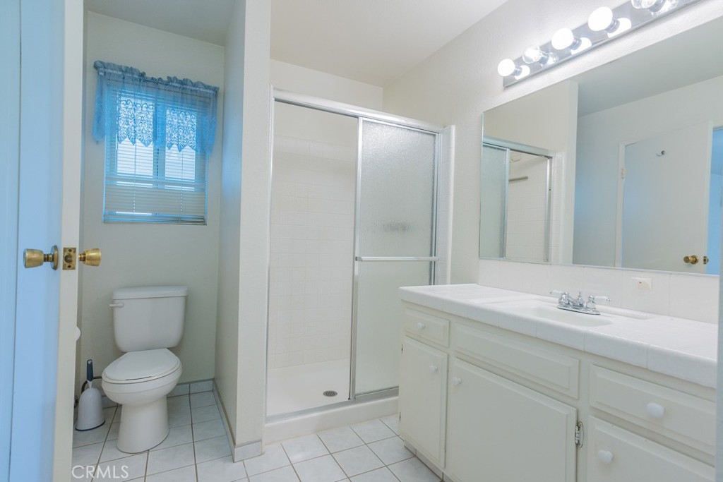 4628 West Ave K8 Quartz Hill, CA 93536 - Photo 27 of 57 a bathroom with a toilet sink and mirror