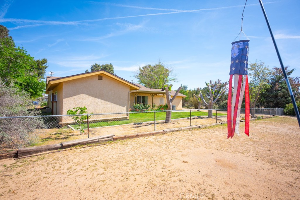 4628 West Ave K8 Quartz Hill, CA 93536 - Photo 34 of 57 a view of a house with a backyard and a tree
