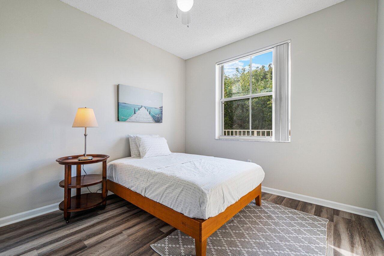 2040 Greenview Shores Boulevard, Unit 223 Wellington, FL 33414 - Photo 14 of 15 a bedroom with a bed and window