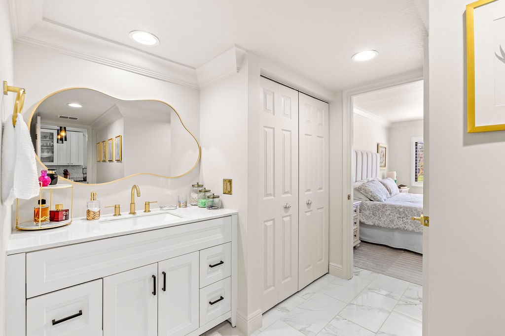 2400 South Ocean Drive, Unit 913 Fort Pierce, FL 34949 - Photo 17 of 36 a en suite bathroom with a double vanity sink and a mirror