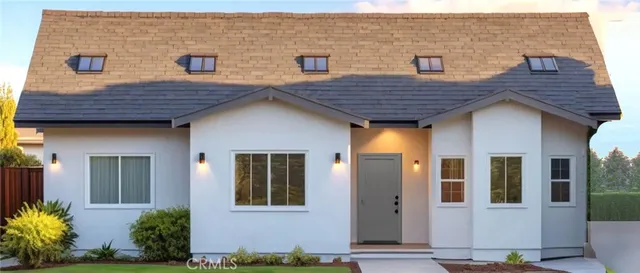 a view of brick house with potted plants