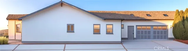 a view of brick house with potted plants