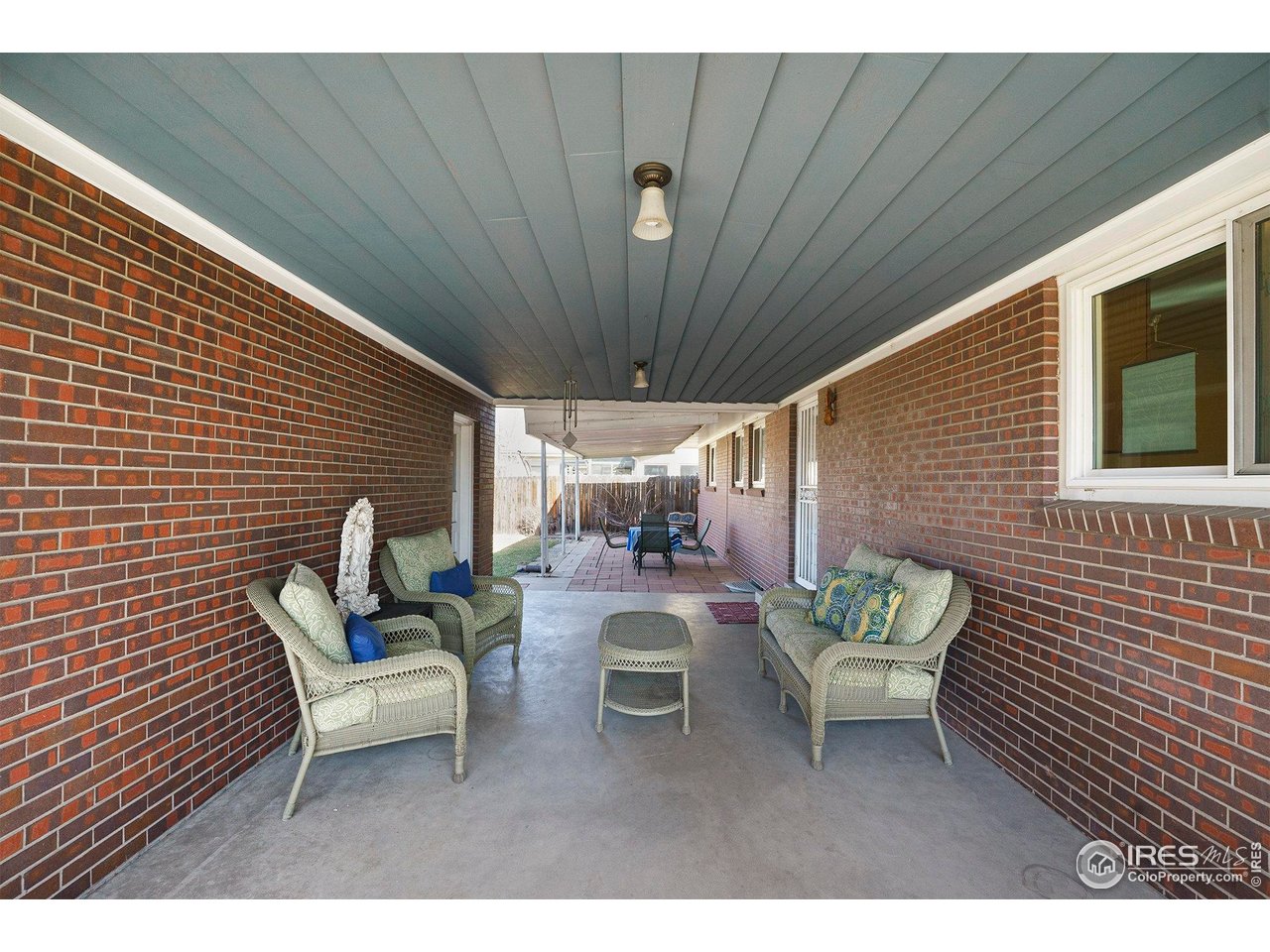 4105 Yarrow Court Wheat Ridge, CO 80033 - Photo 20 of 26 Covered Patio connecting garage to the house.