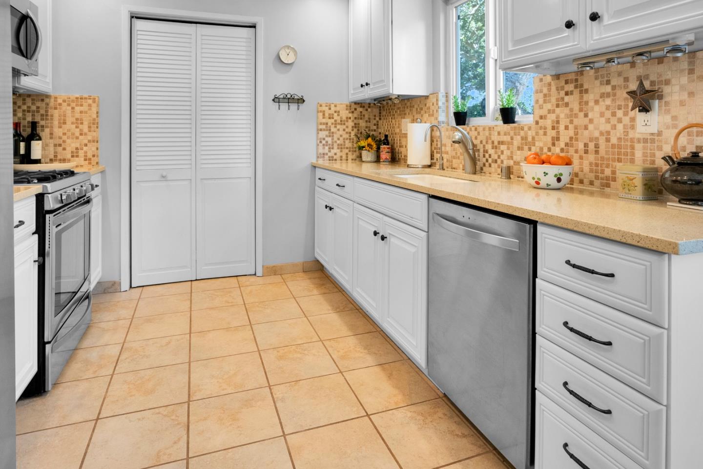 455 San Bernabe Drive Monterey, CA 93940 - Photo 14 of 32 a kitchen with stainless steel appliances a sink and cabinets