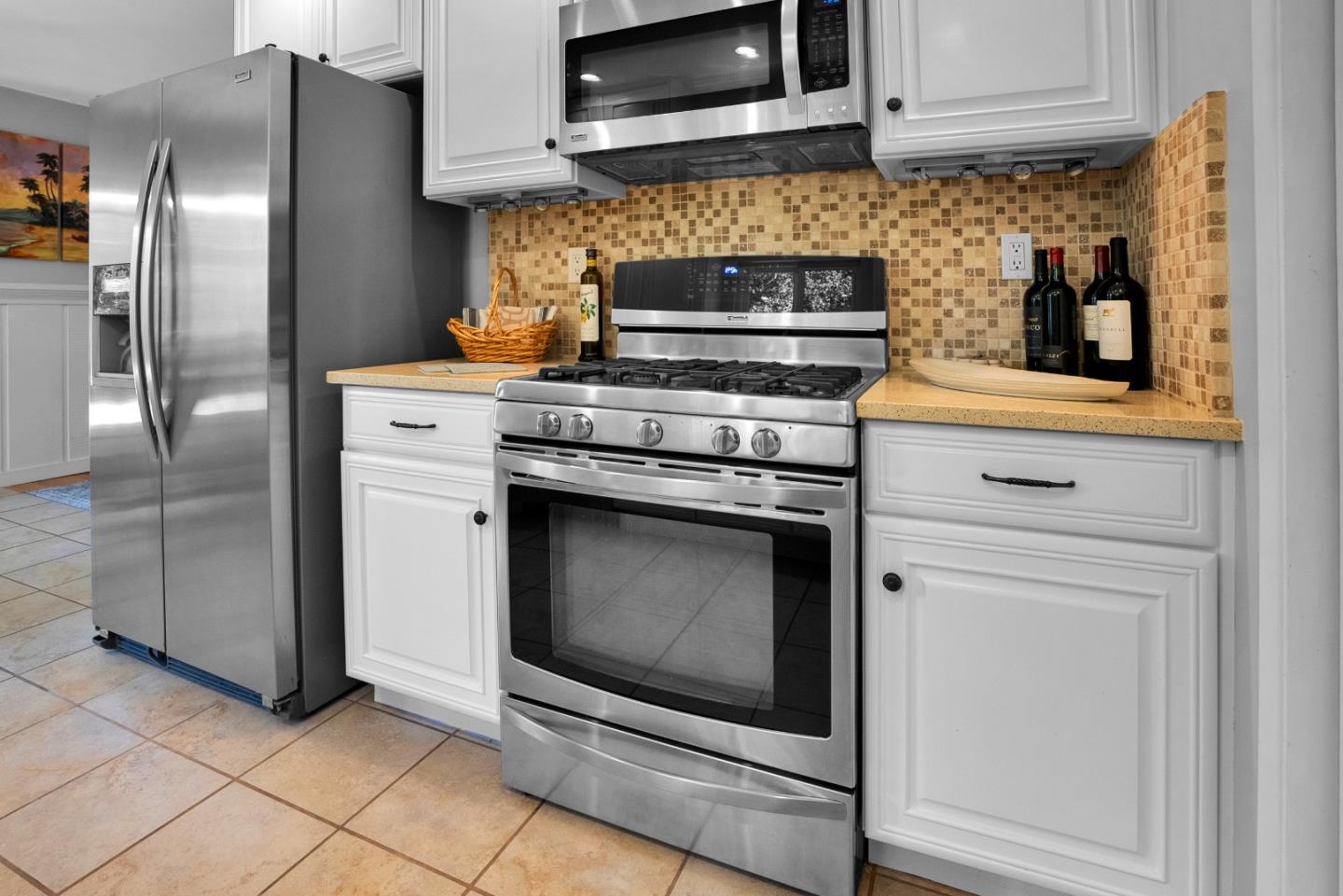 455 San Bernabe Drive Monterey, CA 93940 - Photo 15 of 32 a kitchen with stainless steel appliances granite countertop a stove microwave and refrigerator