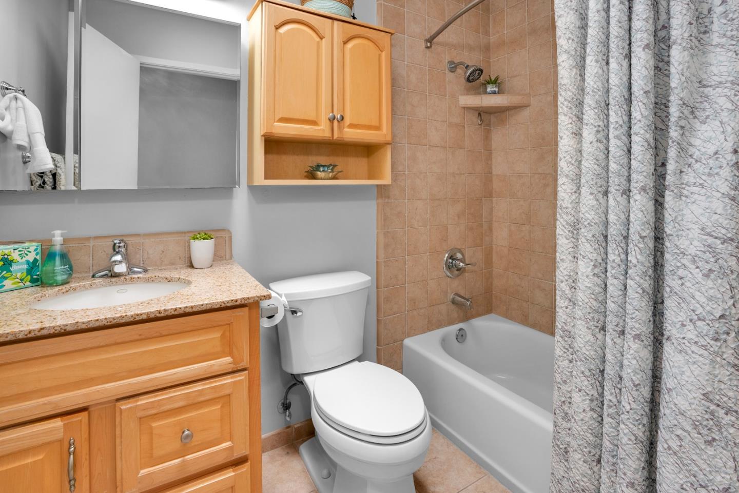 455 San Bernabe Drive Monterey, CA 93940 - Photo 24 of 32 a bathroom with a granite countertop toilet a sink and a bathtub