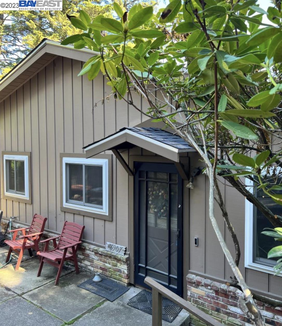 a backyard of a house with outdoor seating