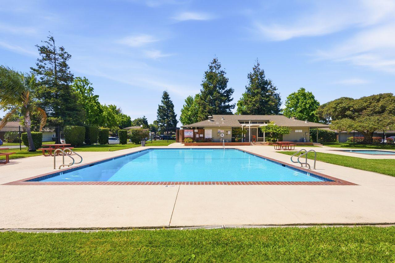 5561 Roundtree Common Fremont, CA 94538 - Photo 25 of 29 a view of a swimming pool with an outdoor seating and a yard