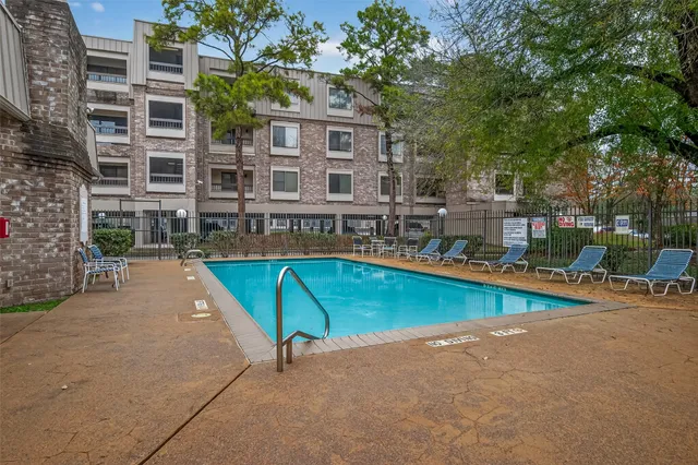 a view of a swimming pool with a lounge chairs
