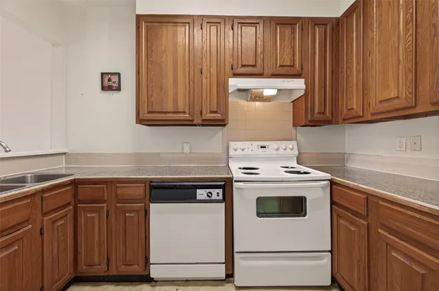 a kitchen with appliances and cabinets
