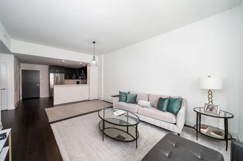 a living room with furniture and a chandelier