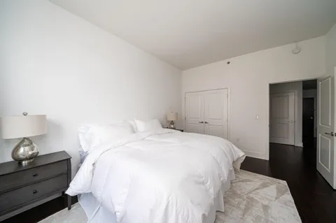 a bedroom with a bed and a lamp