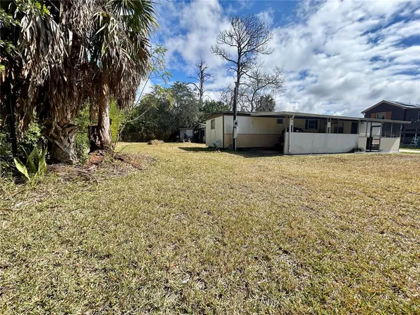 a backyard of a house with large trees