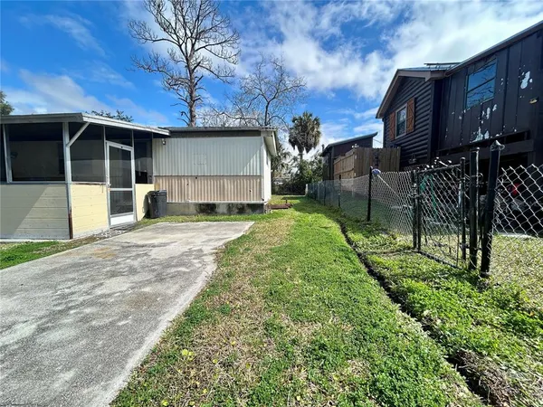 a view of a house with a yard and pathway