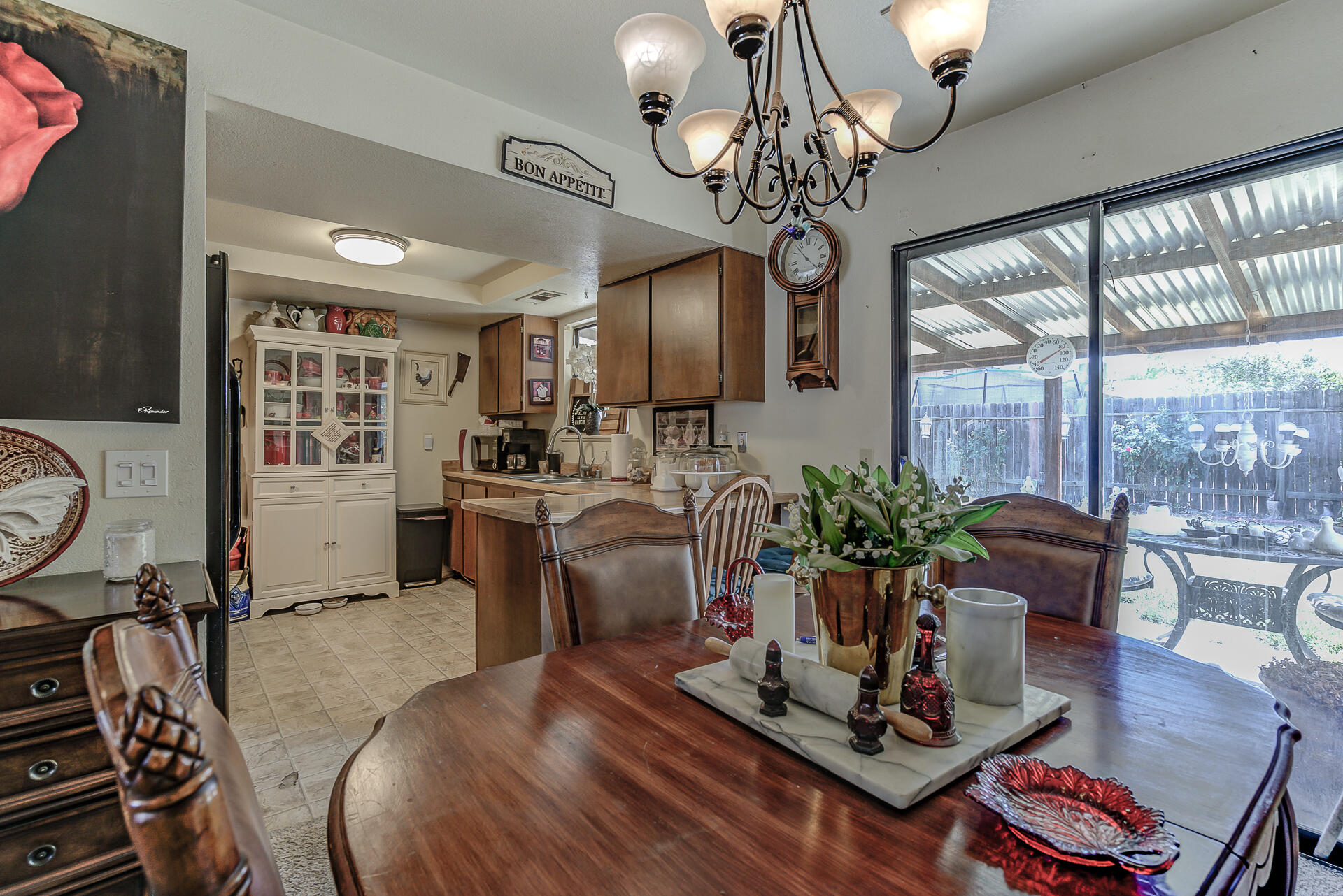 1240 Beltline Road Redding, CA 96003 - Photo 8 of 21 a living room with furniture a chandelier and a floor to ceiling window
