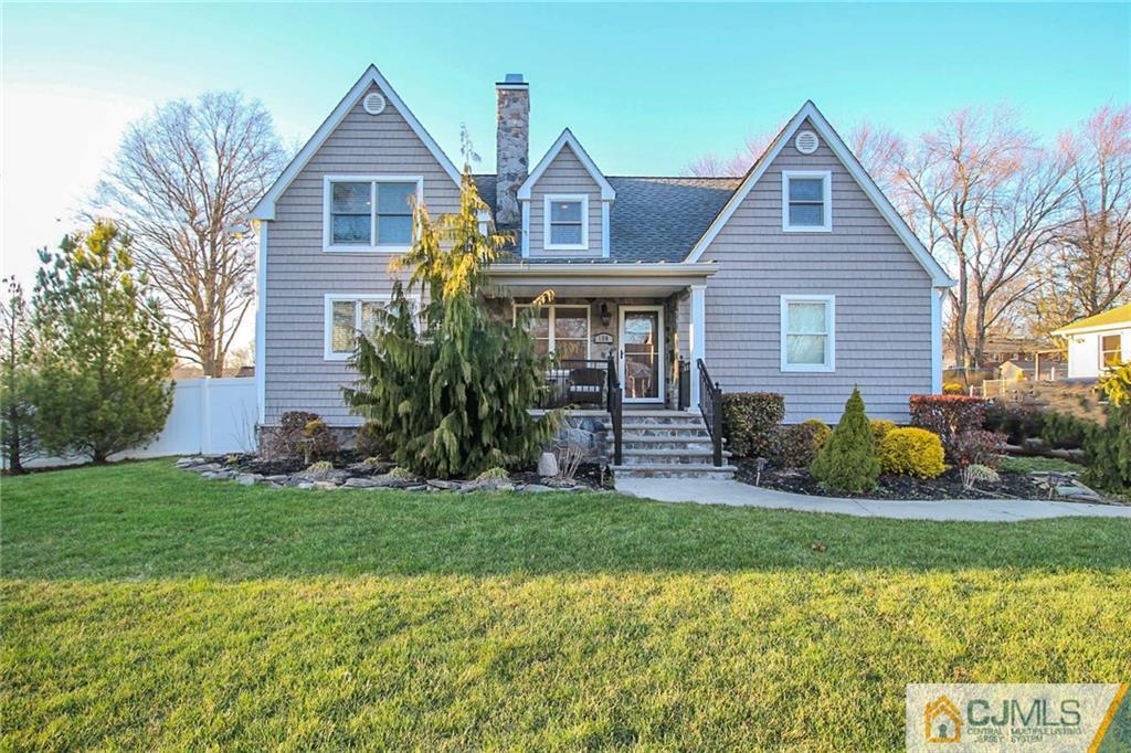 128 Morningside Road Colonia, NJ 07067 - Photo 1 of 25 a front view of a house with a yard and garage