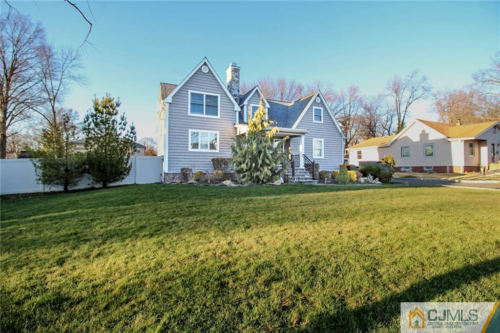 128 Morningside Road Colonia, NJ 07067 - Photo 2 of 25 a front view of a house with a yard
