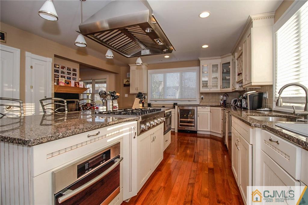 128 Morningside Road Colonia, NJ 07067 - Photo 11 of 25 a large kitchen with stainless steel appliances granite countertop a lot of counter space and a sink