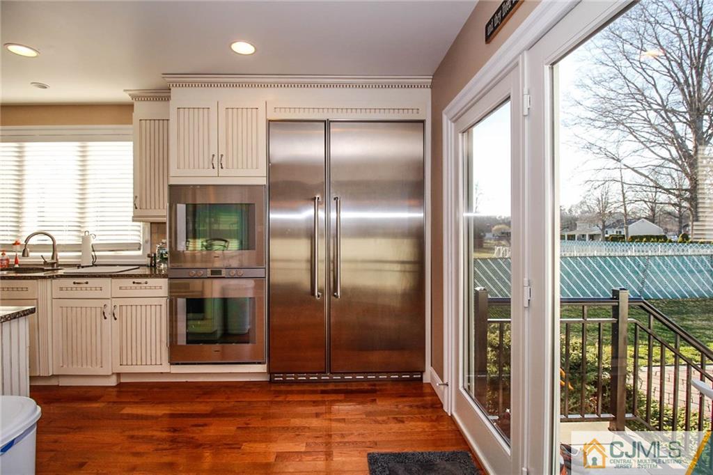 128 Morningside Road Colonia, NJ 07067 - Photo 12 of 25 a kitchen with kitchen island granite countertop a refrigerator and a sink