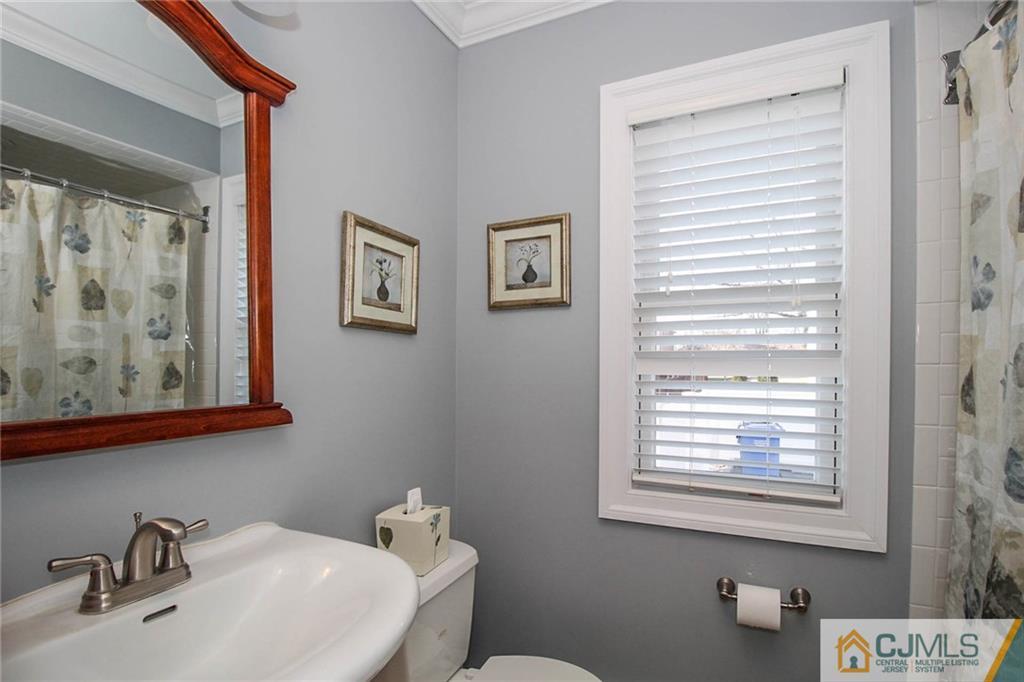 128 Morningside Road Colonia, NJ 07067 - Photo 14 of 25 a bathroom with a sink a toilet and a window