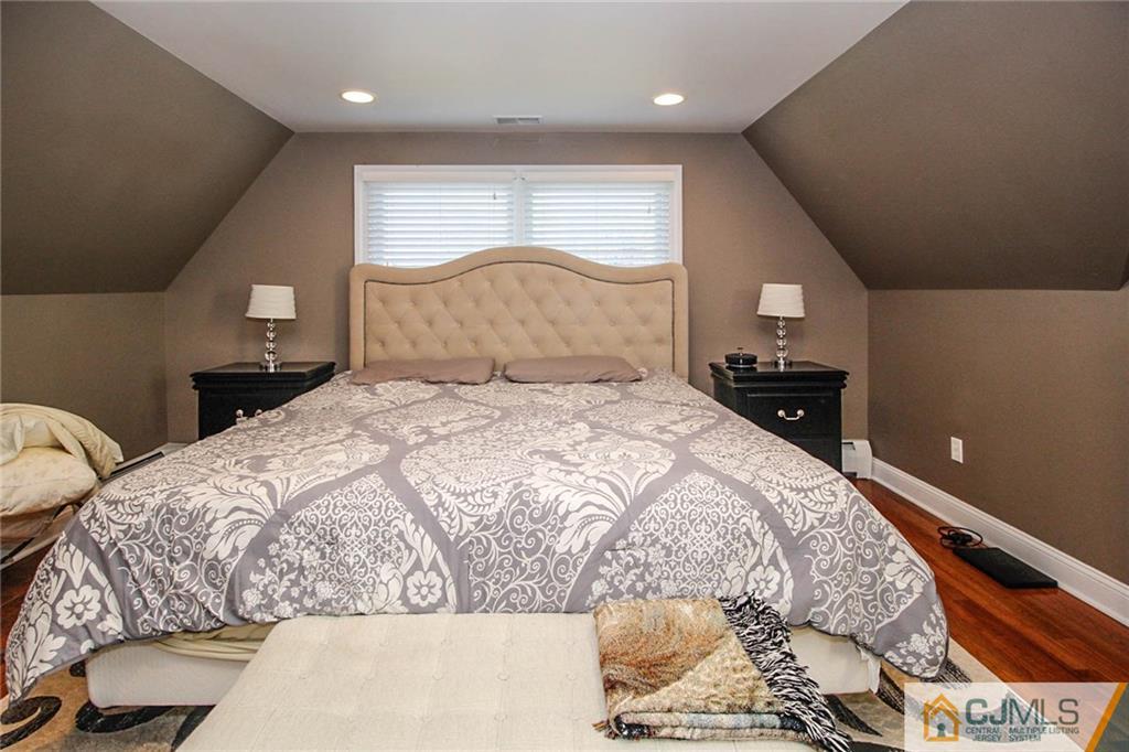128 Morningside Road Colonia, NJ 07067 - Photo 15 of 25 a bedroom with a bed and a lamp
