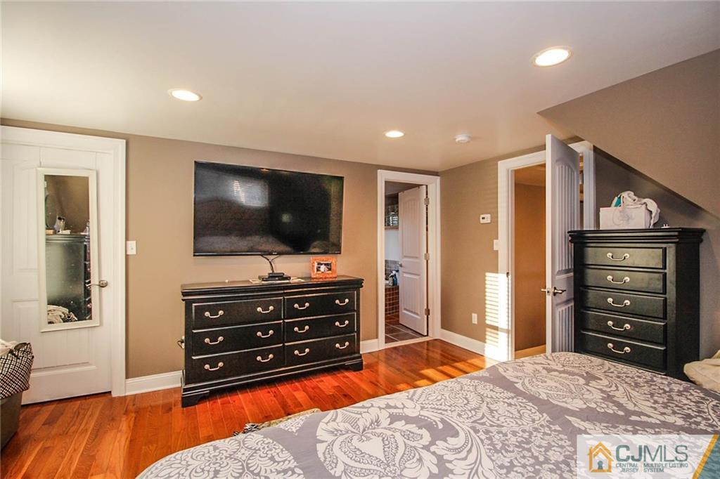 128 Morningside Road Colonia, NJ 07067 - Photo 16 of 25 a living room with furniture and a flat screen tv