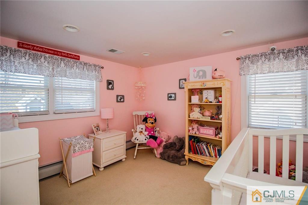 128 Morningside Road Colonia, NJ 07067 - Photo 19 of 25 a bedroom with furniture and a book shelf