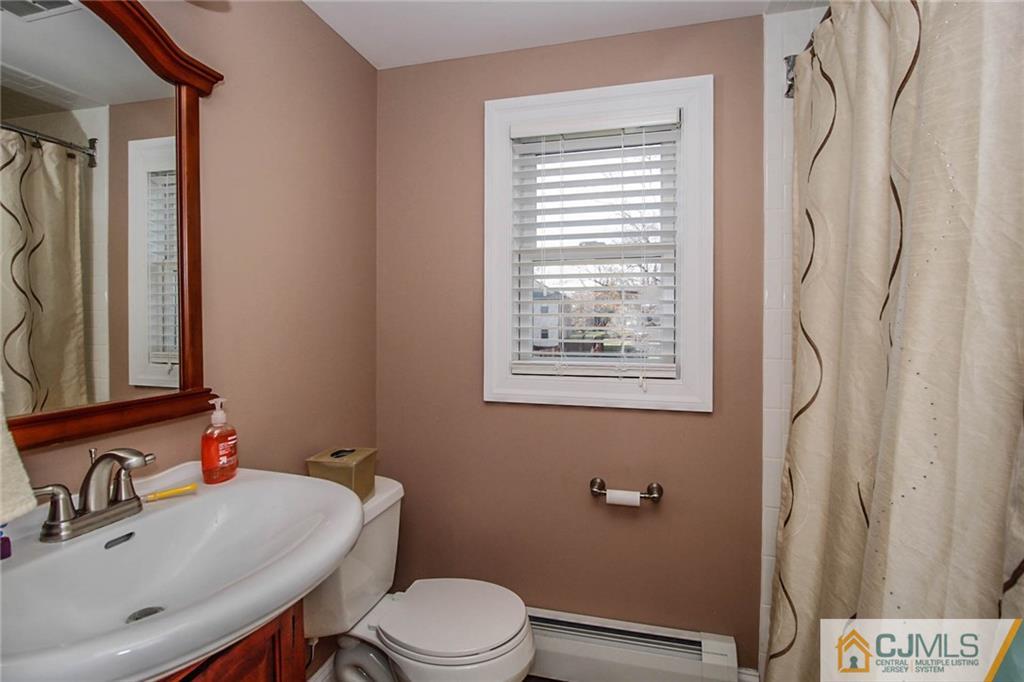 128 Morningside Road Colonia, NJ 07067 - Photo 20 of 25 a bathroom with a sink vanity mirror and toilet