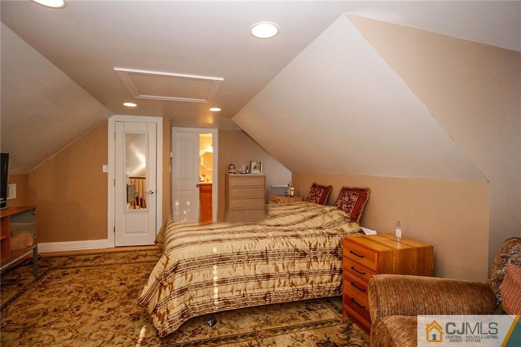 128 Morningside Road Colonia, NJ 07067 - Photo 22 of 25 a bedroom with a bed and a flat screen tv