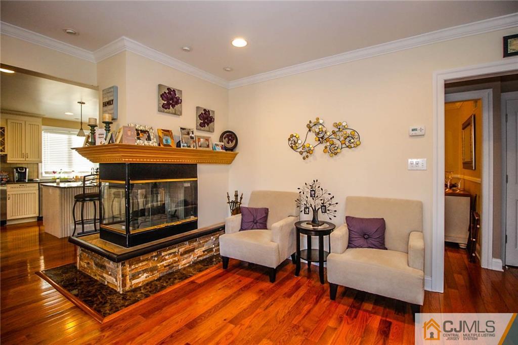 128 Morningside Road Colonia, NJ 07067 - Photo 4 of 25 a living room with furniture and a fireplace