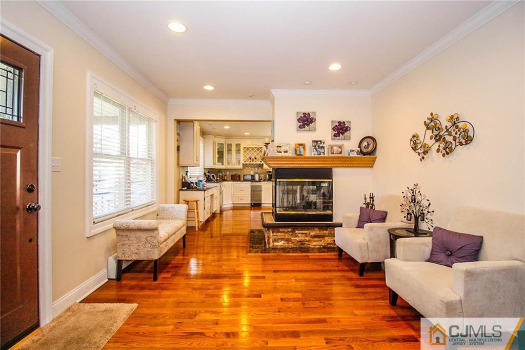 128 Morningside Road Colonia, NJ 07067 - Photo 5 of 25 a living room with furniture and a fireplace