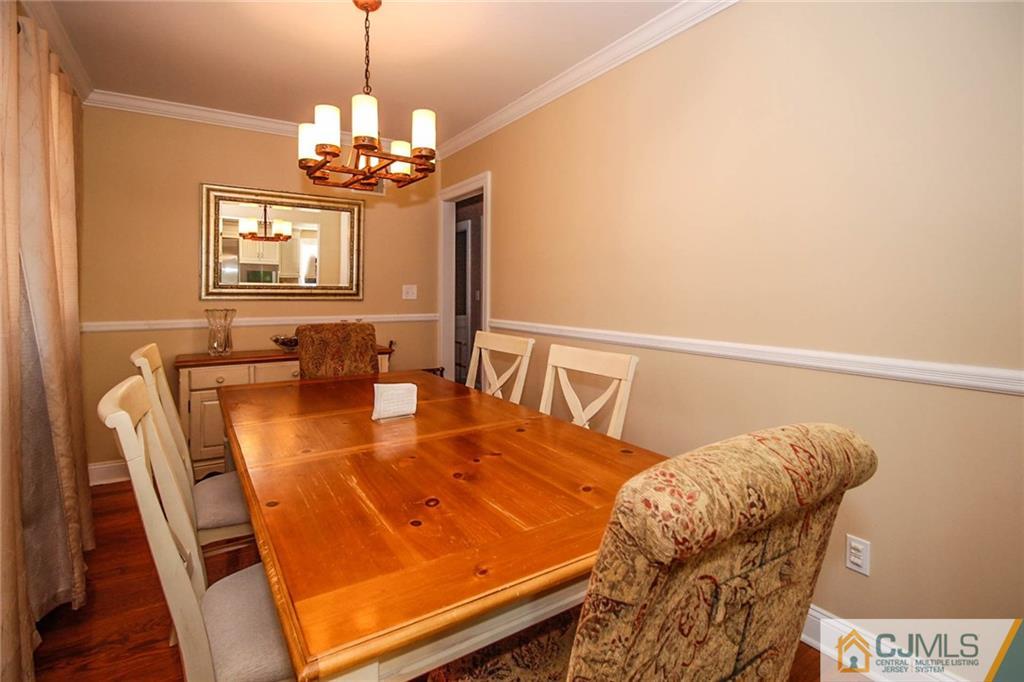 128 Morningside Road Colonia, NJ 07067 - Photo 7 of 25 a dining room with furniture and chandelier