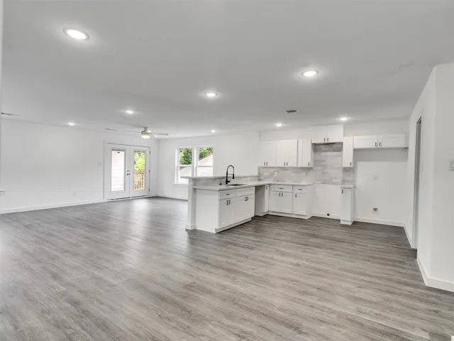a bathroom with a bathtub shower sink mirror and toilet