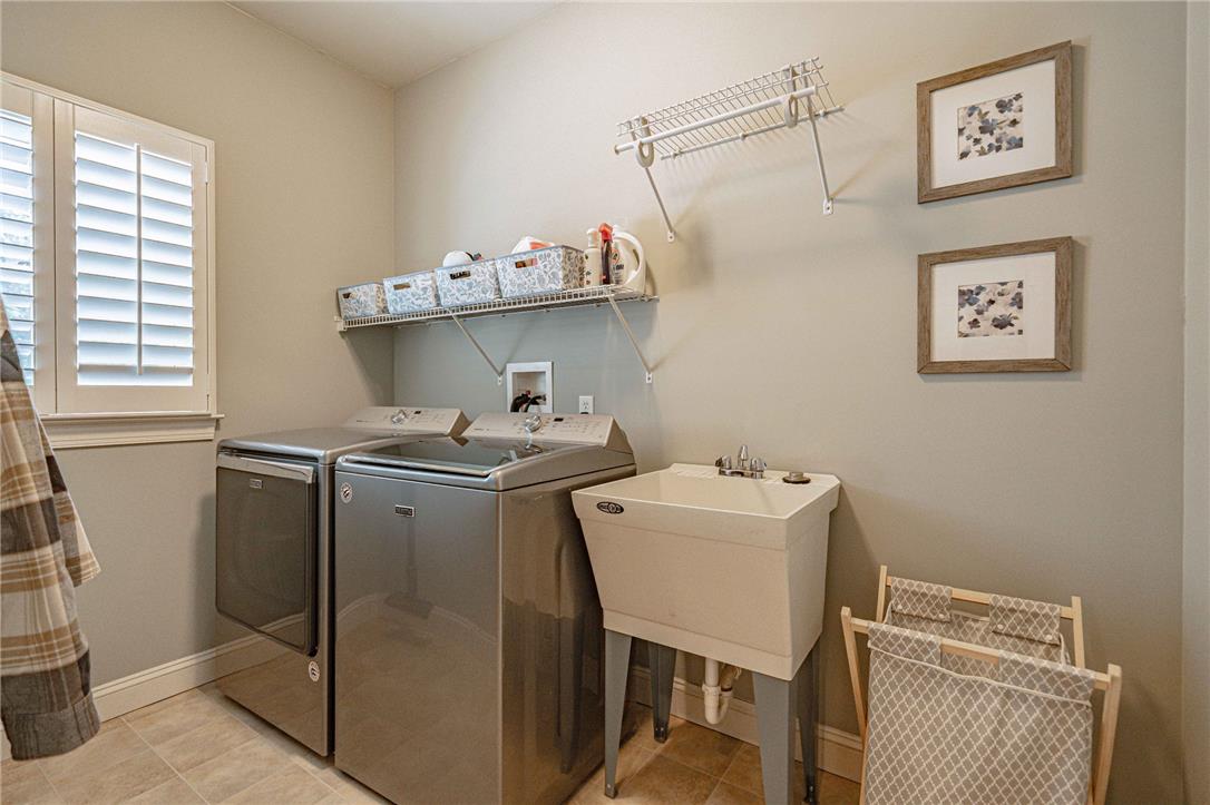 6000 Pond View Terrace Bath, PA 18014 - Photo 20 of 69 Functional laundry room equipped with washer, dryer, and utility sink, simplifying household chores.