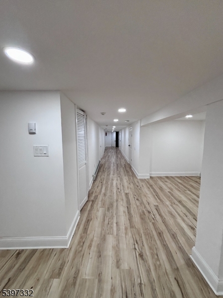 48 North York Street, Unit 1F Paterson, NJ 07524 - Photo 12 of 18 a view of a hallway with wooden floor