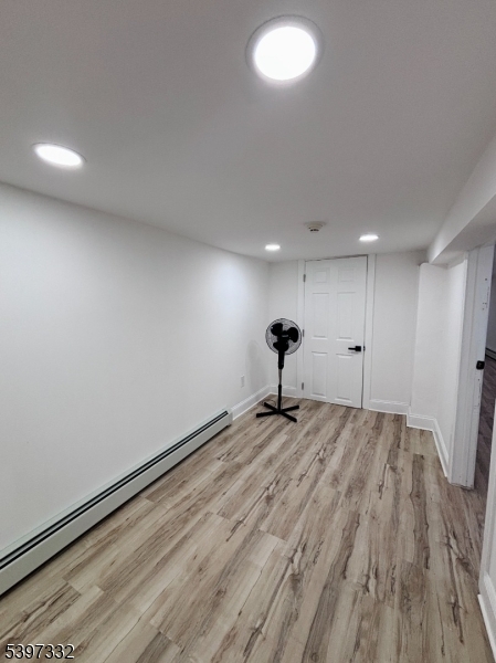 48 North York Street, Unit 1F Paterson, NJ 07524 - Photo 15 of 18 a view of an empty room and wooden floor