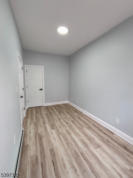 48 North York Street, Unit 1F Paterson, NJ 07524 - Photo 8 of 18 a view of empty room with wooden floor