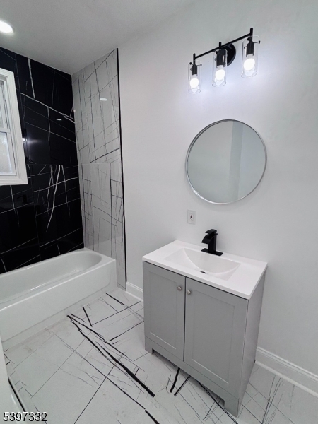 48 North York Street, Unit 1F Paterson, NJ 07524 - Photo 10 of 18 a bathroom with a sink a toilet a mirror and shower