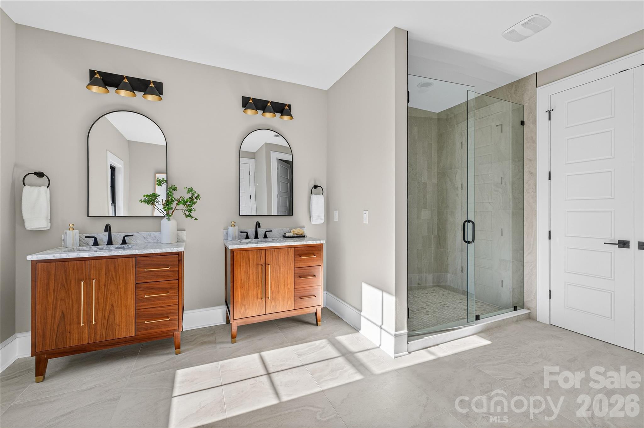 6811 Burlwood Road Charlotte, NC 28211 - Photo 27 of 43 a bathroom with a double vanity sink mirror and shower